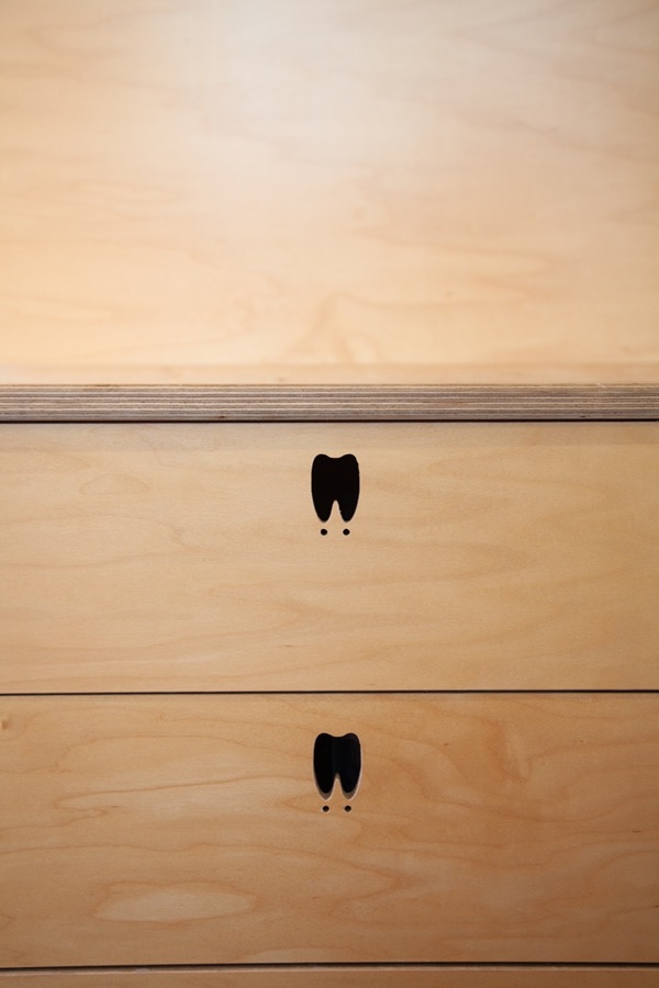 A tooth-shaped drawer pull inside the Wheely Clean mobile clinic