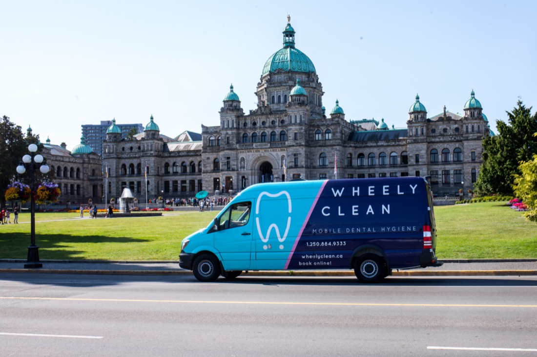 A Wheely Clean van parked in front of the BC Legislature building